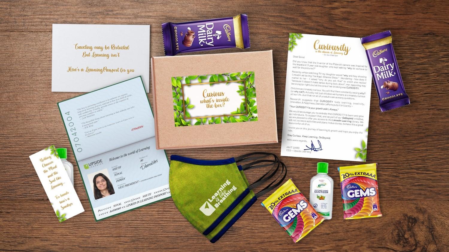 Collection of Curiosity Boosters: Letter on the Importance of Curiosity, LinkedIn Learning Passport, Sanitizers, Masks with 'Learning is like Breathing' Text, and Delicious Chocolates