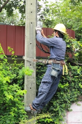 Electrician Working On A Pole